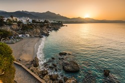 The sun rises over Nerja