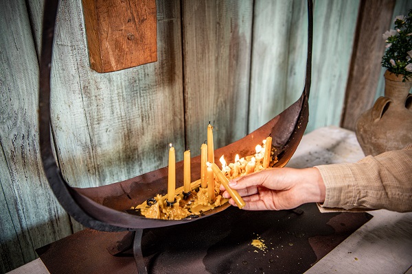 Candles are lit in the small wooden church in Bork Vikingehavn