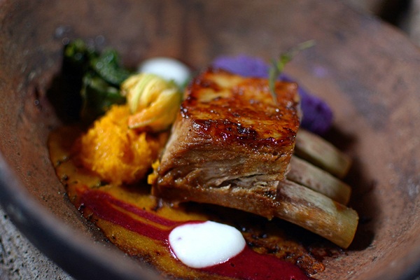 An elegantly plated dish with roast and gravy
