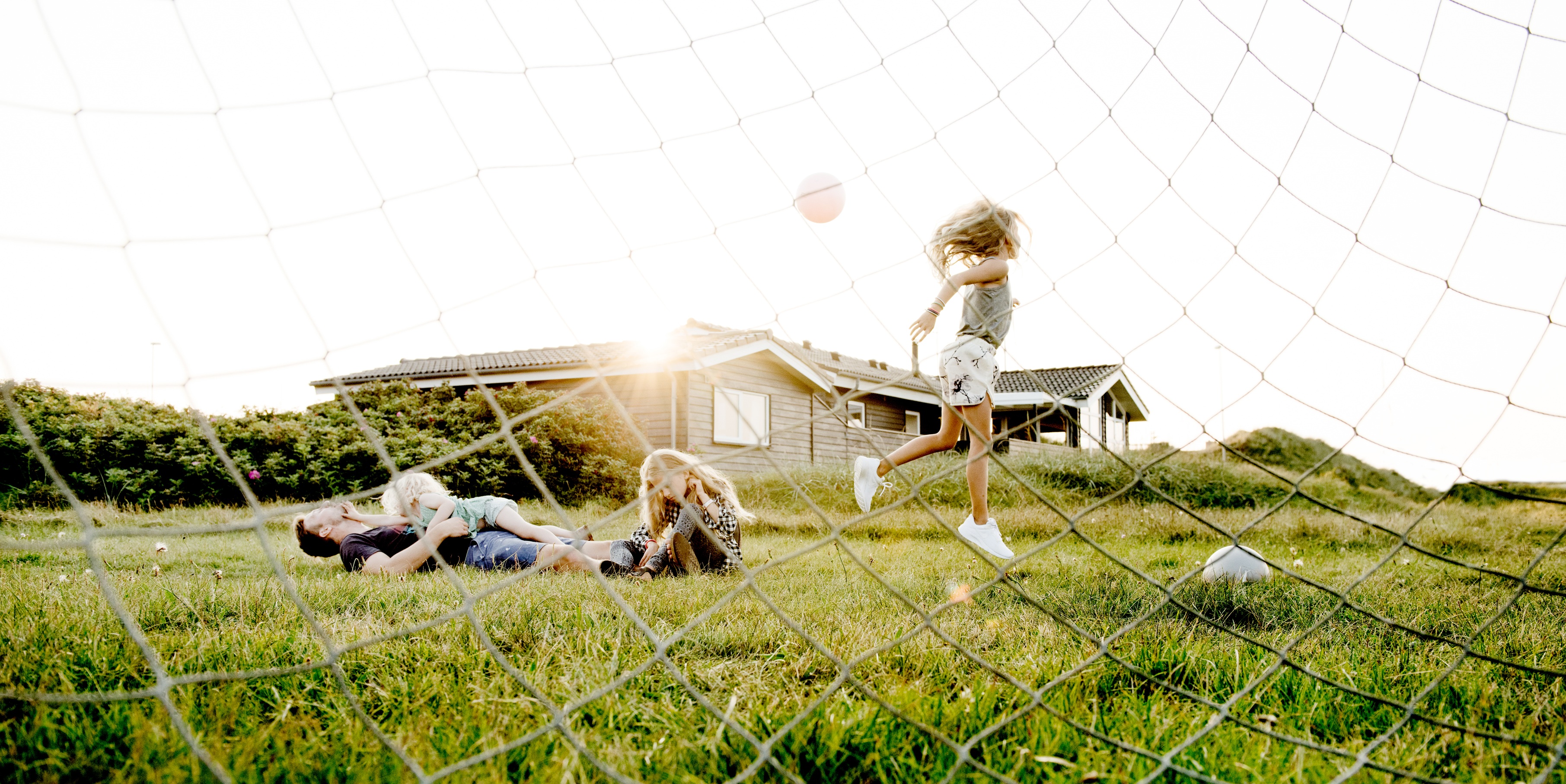A family playing football in a Danish holiday home
