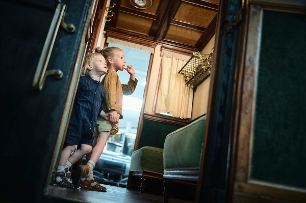 Kids in a historic train compartment at the Danish Railway Museum