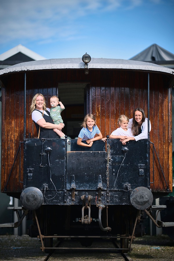 Family on the old train at the Danish Railway Museum