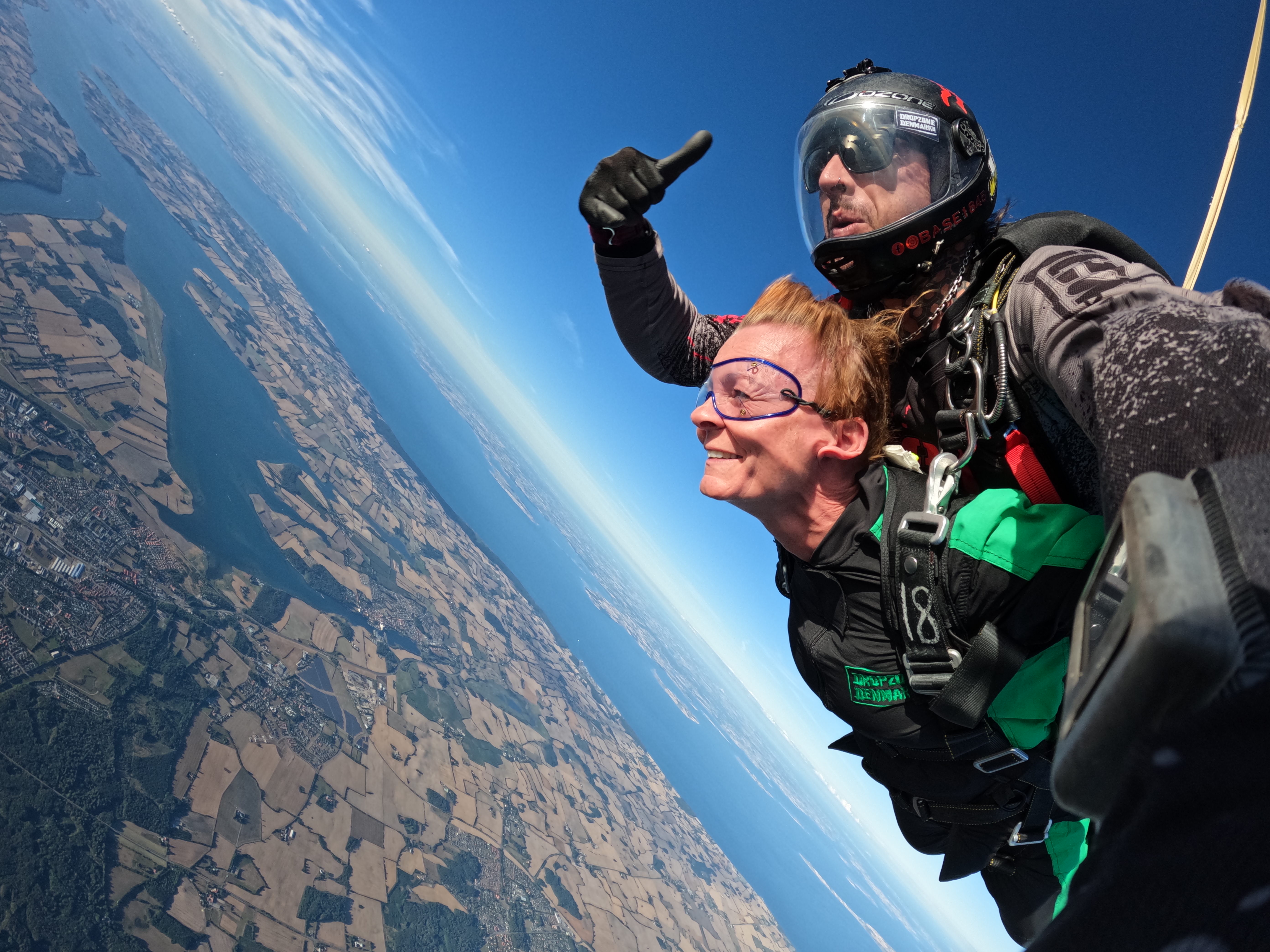 A woman tandem jumps with an instructor
