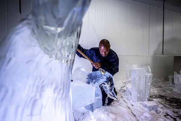 An ice artist sculpting