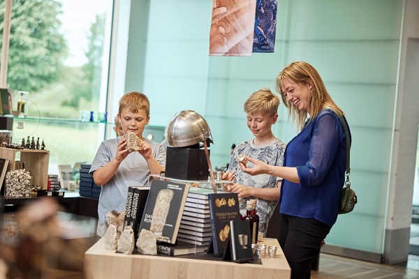 A family looks at the merchandise in the Kongernes Jelling museum store