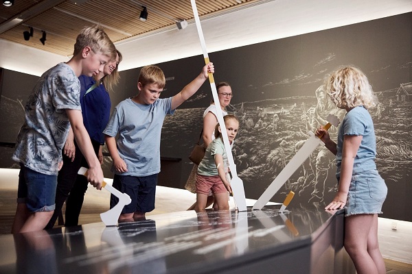 Children try out Viking weapons at the Kongernes Jelling Museum experience center