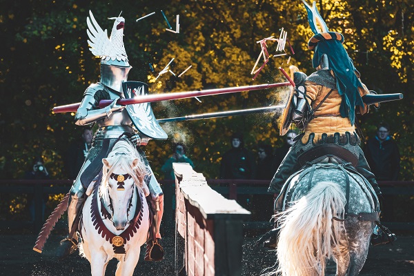 Two knights on horseback fighting each other
