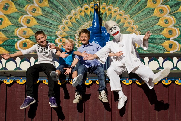 Three boys together on stage with Pierrot