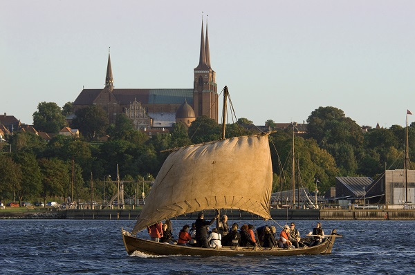 A reconstructed Viking ship sails across the fjord near Roskilde