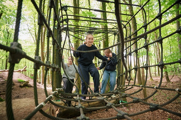 Three teenage girls climb at WOW PARK